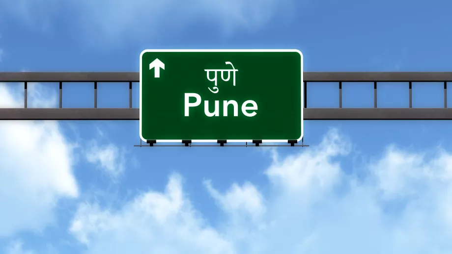 A road sign for Pune, India