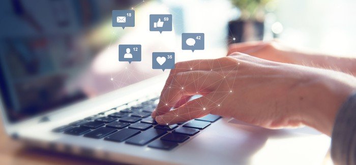 Social media manager working on laptop