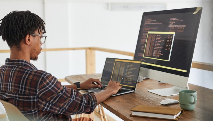 computer skills, man writing code on computer