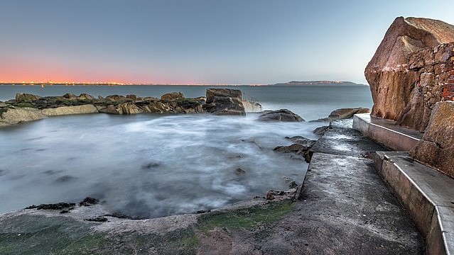 A path leads to a rock pool overlooking Dublin