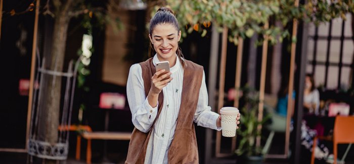 Young woman with reusable coffee cup