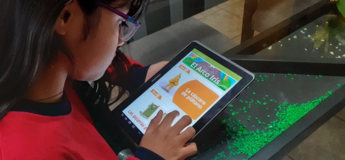Child learning to read on tablet 