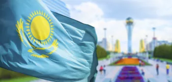 Kazakhstan flag against Shymkent background