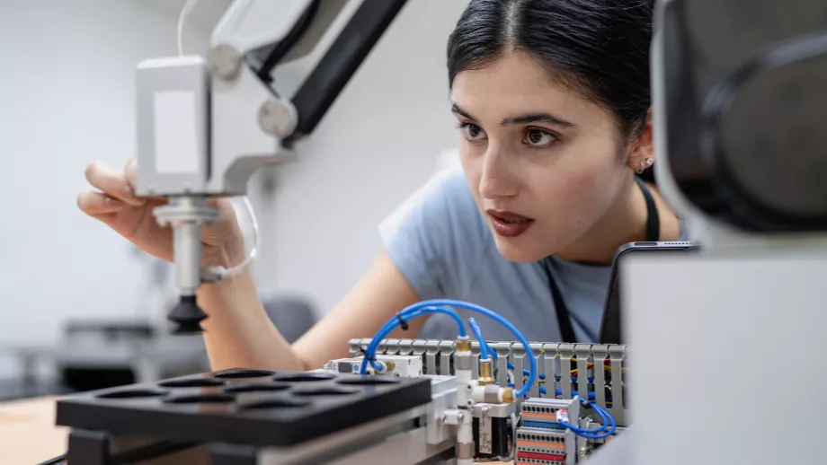Female student working with AI in laboratory