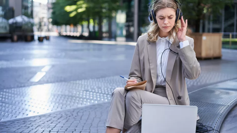 Woman looking at her laptop confused
