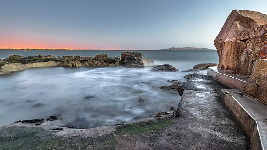 A path winds into a rock pool looking over Dublin