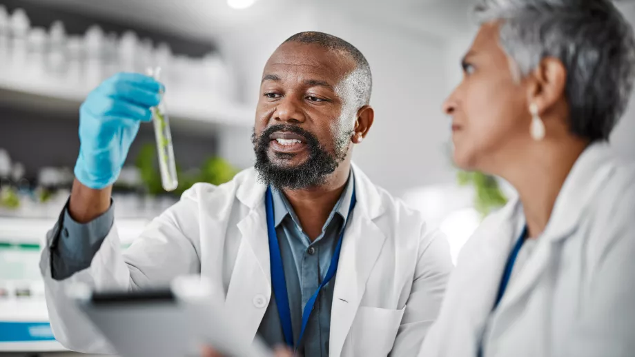 Mature medical students hold a test tube